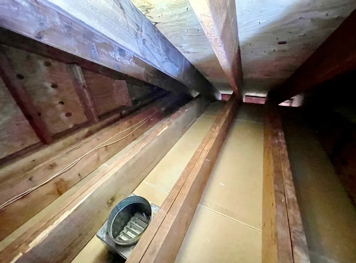 Attic with all insulation removed and surfaces cleaned
