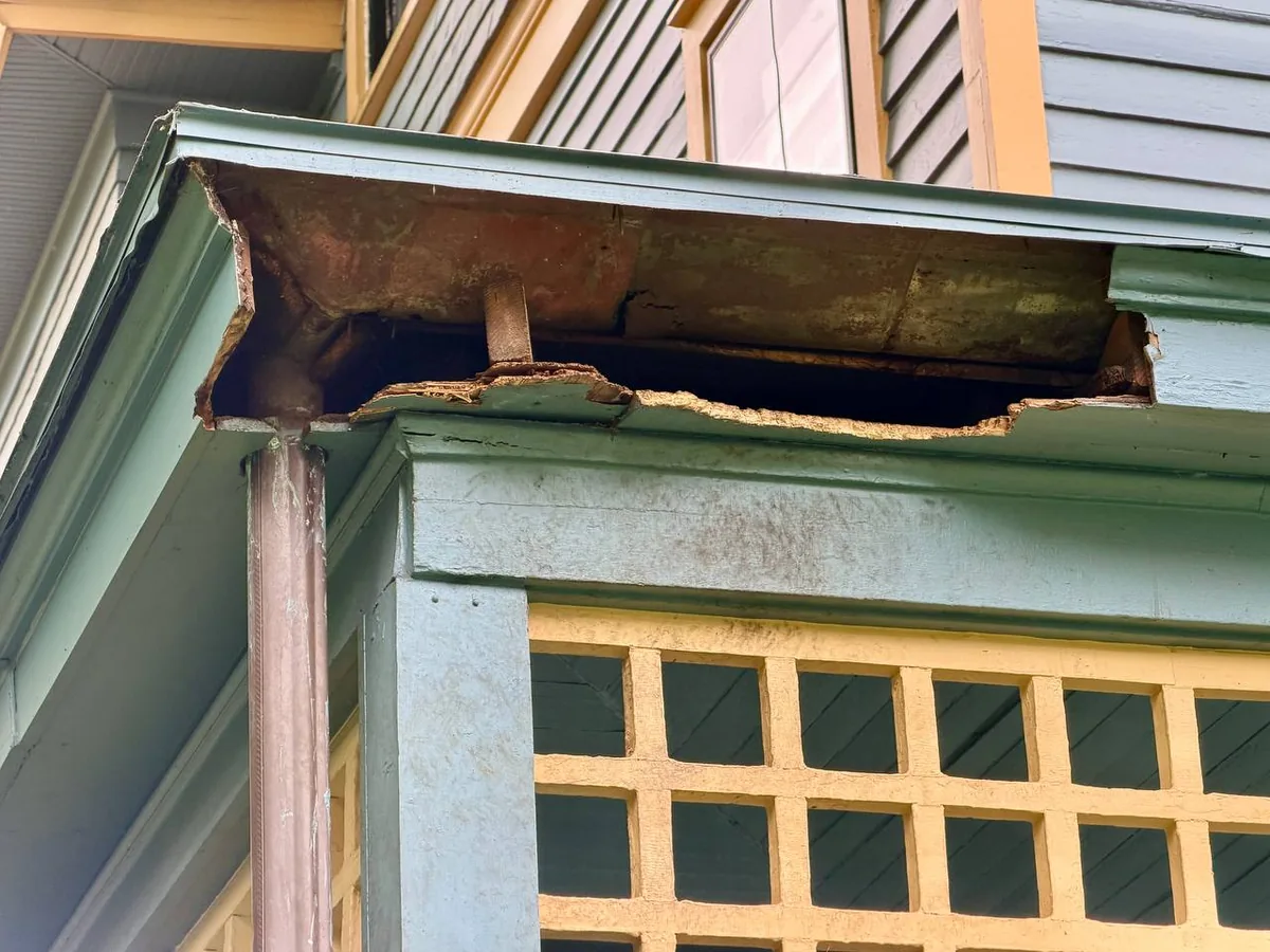 Large holes ripped through a soffit by a raccoon