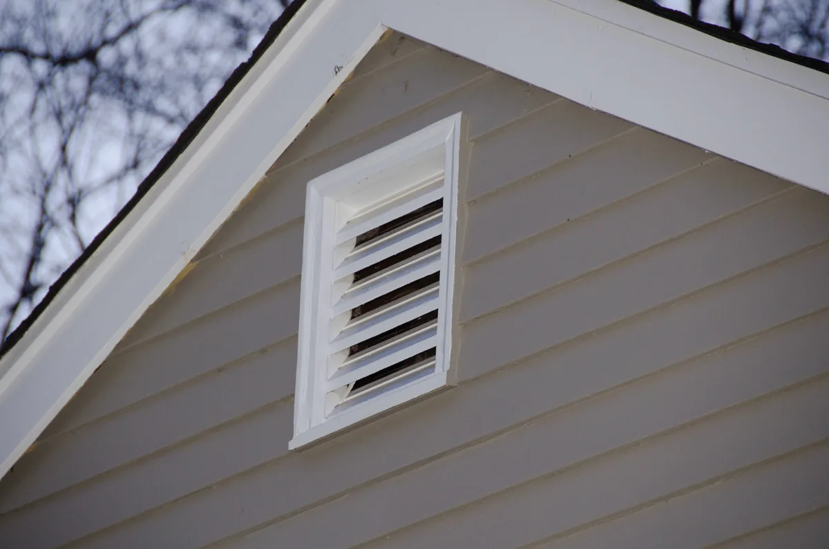 Attic gable vent before screening and gable end fascia boards without caulking