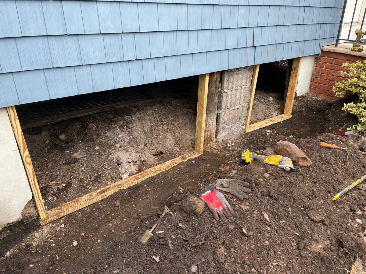 New wood framing installed along the large openings into the crawl space